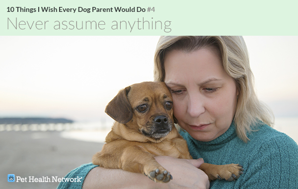 Woman holding dog on the beach