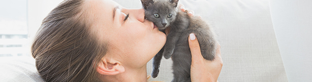 Girl kissing her kitten