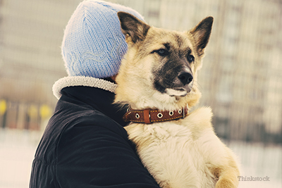 Man carrying dog