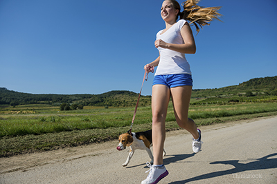 Girl jogging with her dog