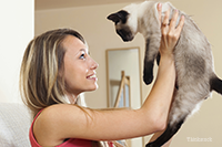 Girl holding up her cat