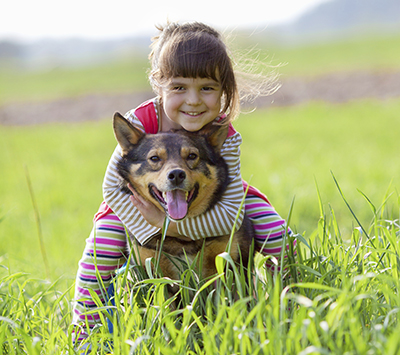 Little girl hugging her dog