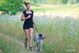 Woman running with dog