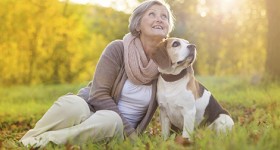 Woman with her dog during the fall season