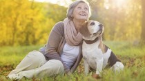 Woman with her dog during the fall season