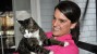 Woman holding reluctant cat