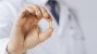 Veterinarian holding a fish oil pill