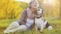 Woman with her dog during the fall season