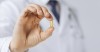 Veterinarian holding a fish oil pill