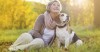 Woman with her dog during the fall season