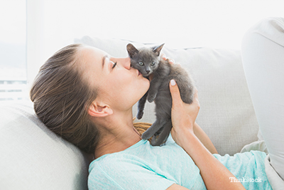 Woman holding up a kitten